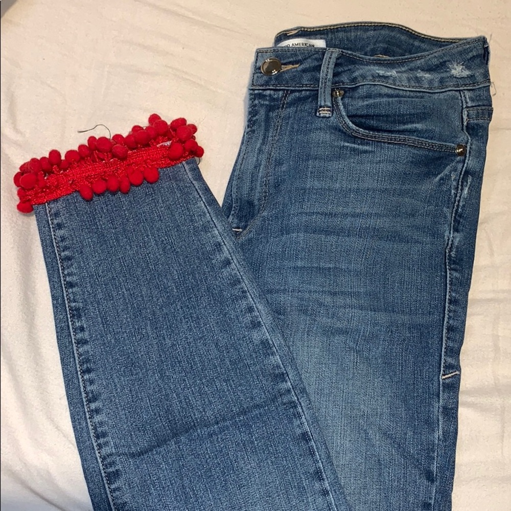 Blue high waisted jeans with red fringe